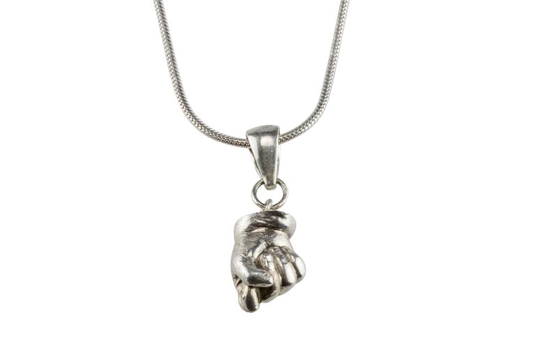 A sterling silver pendant of a baby's closed hand hanging from a simple chain